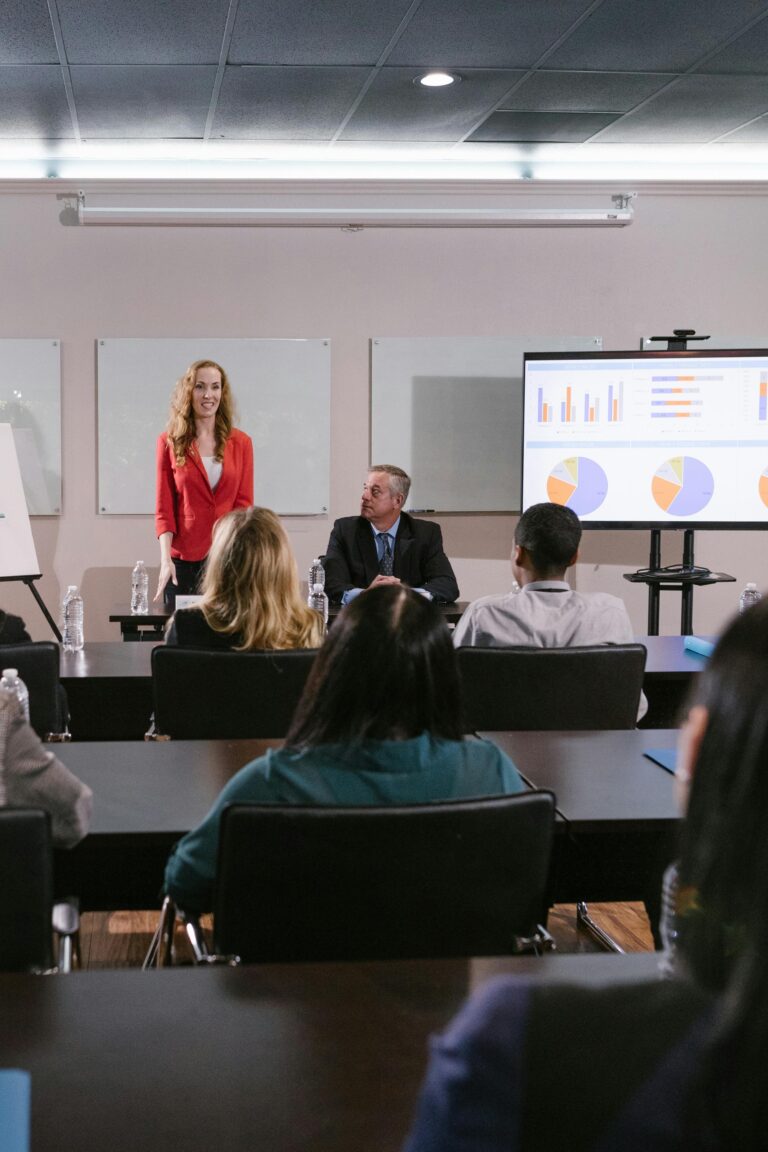 Senior University Leaders discussing strategy in a room with pie charts on a projector in the background.